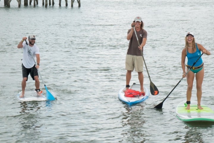 three people on paddle boards