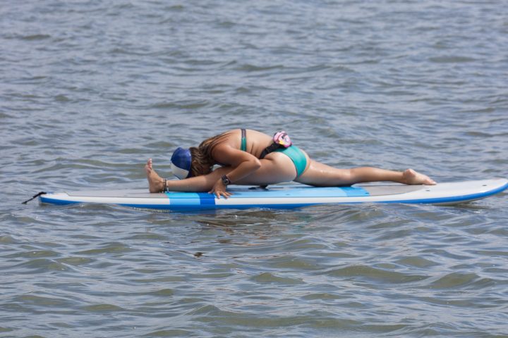 Girl stretching on paddle board