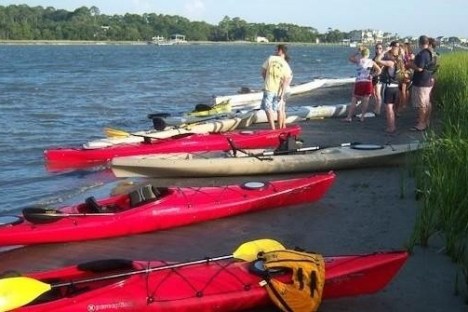a group of people in a small boat in a body of water