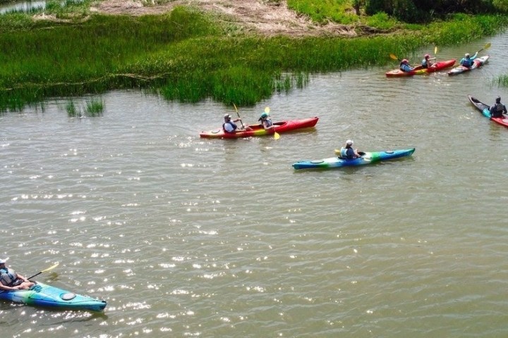 a group of people rowing a boat in the water